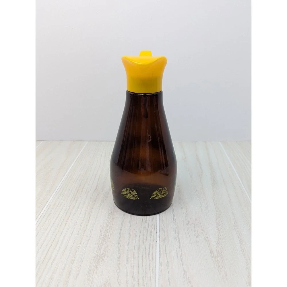Log Cabin vintage syrup dispenser pitcher amber glass yellow lid patriotic eagle